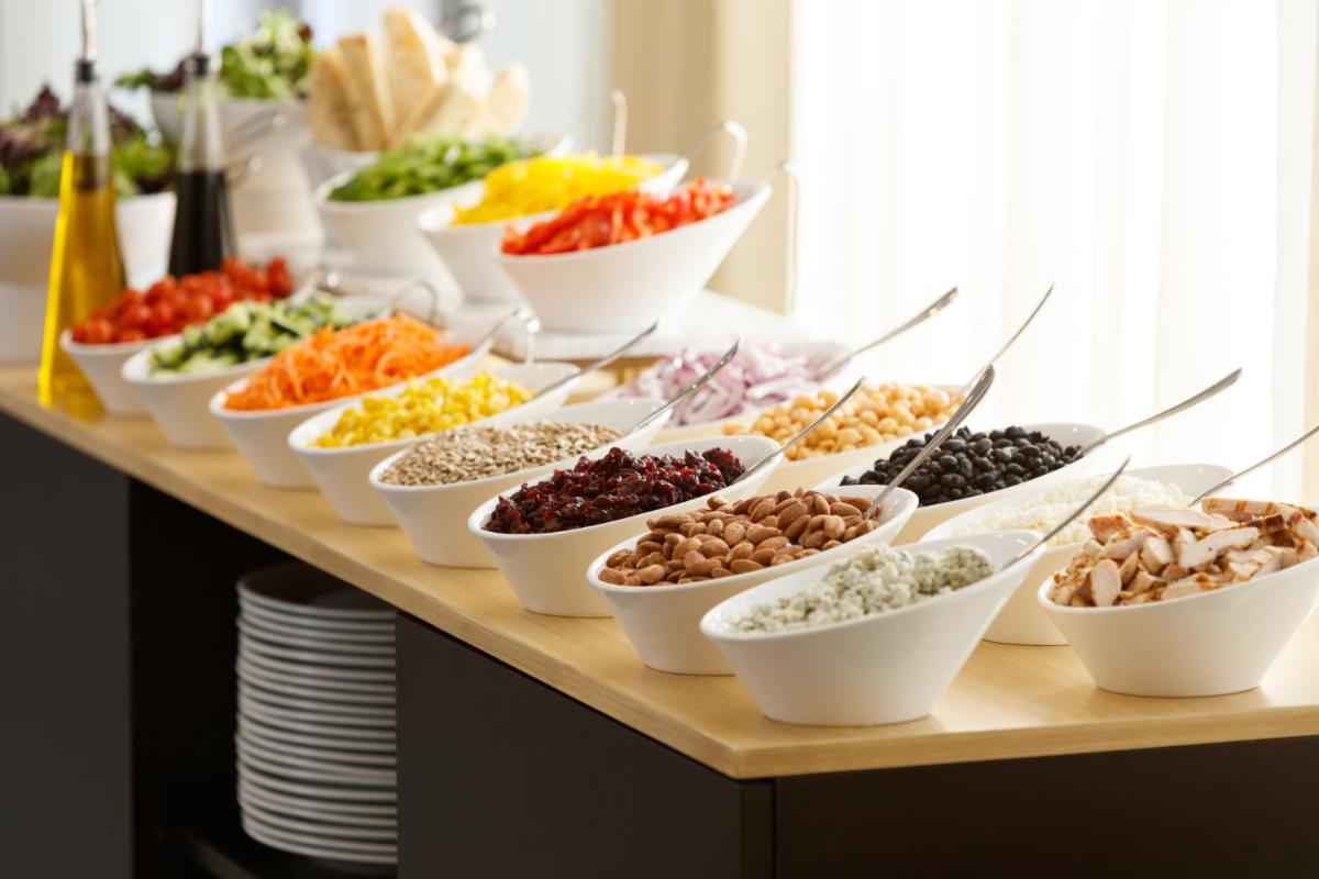 a buffet with many bowls of different types of food at Holiday Inn New Delhi Aerocity by IHG in New Delhi