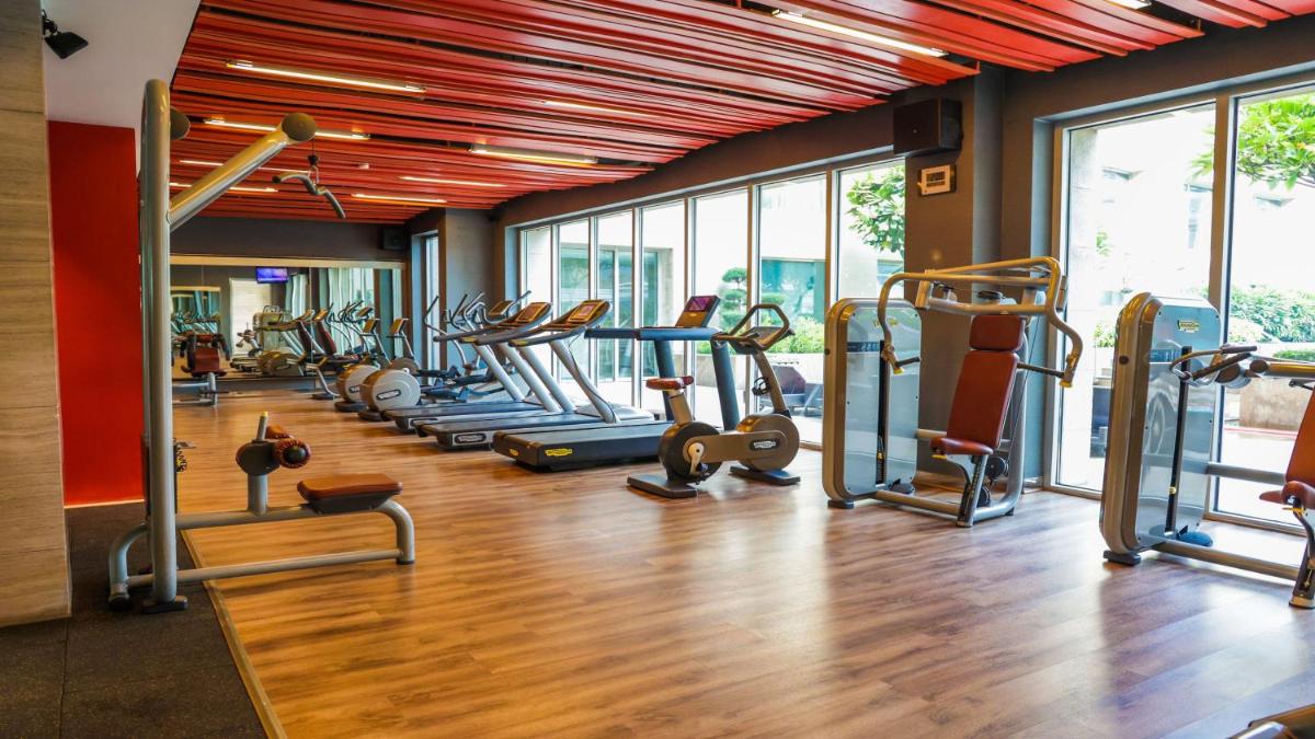 a gym with a lot of treadmills and machines at Holiday Inn New Delhi Aerocity by IHG in New Delhi