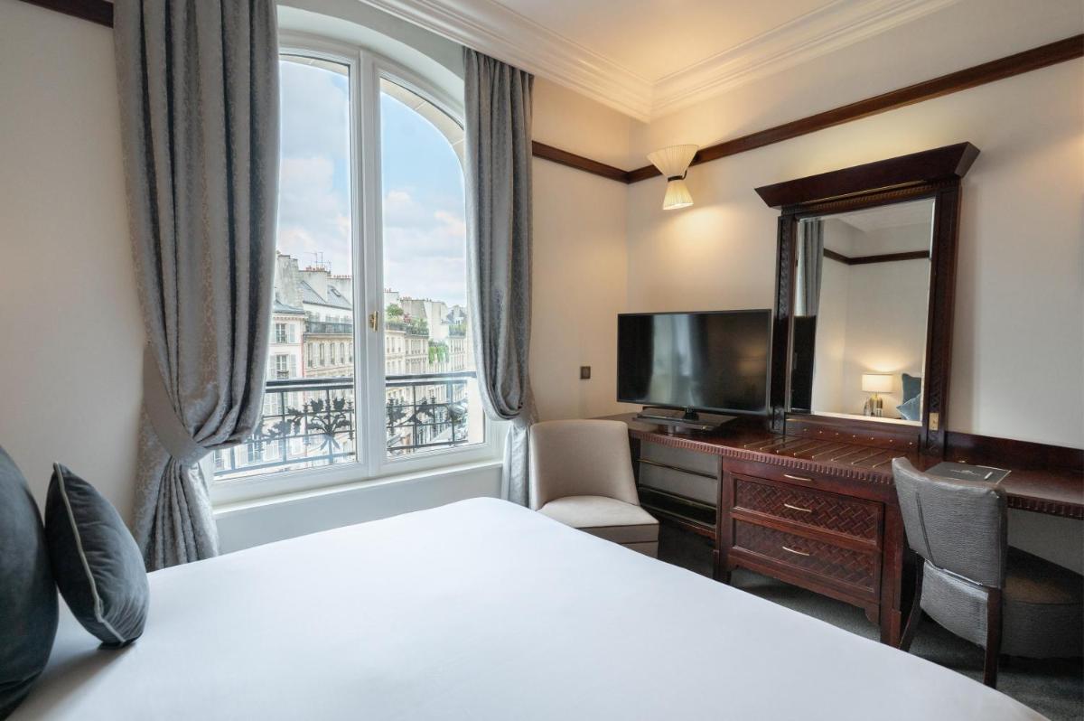Un ou plusieurs lits dans un hébergement de l'établissement Hôtel Pont Royal Paris