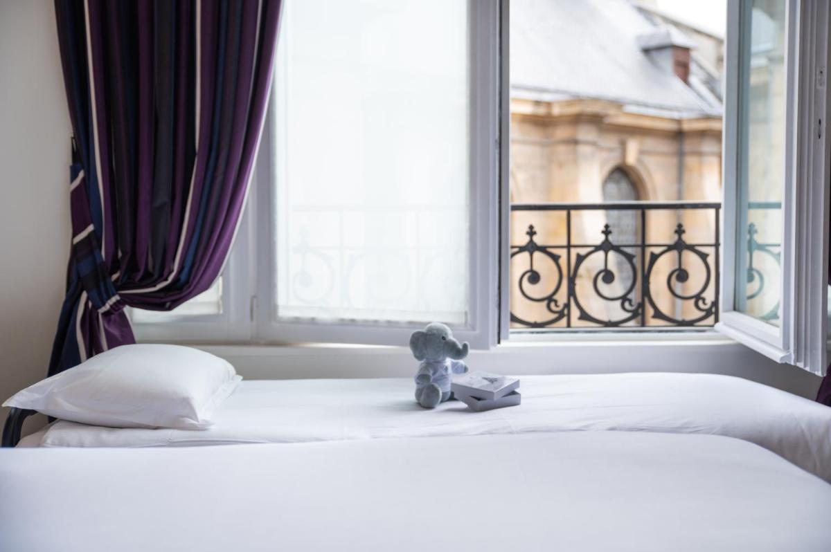 Un ou plusieurs lits dans un hébergement de l'établissement Hôtel Pont Royal Paris