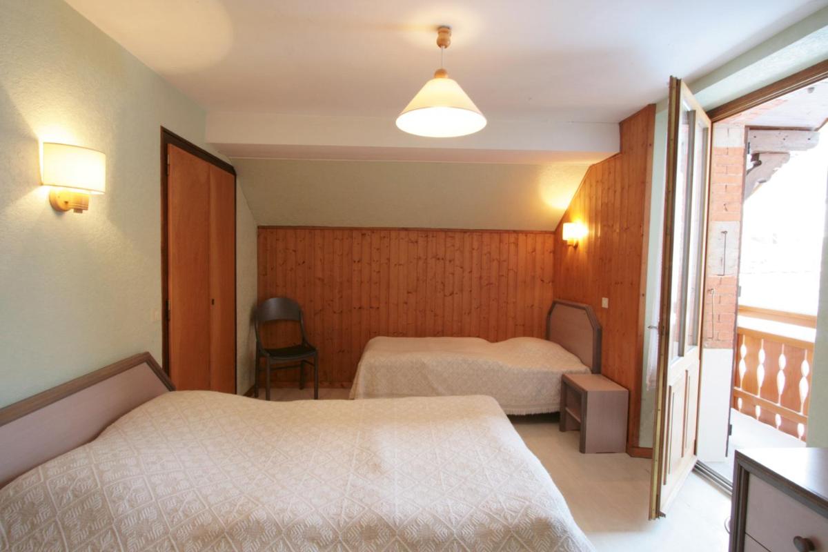 Un ou plusieurs lits dans un hébergement de l'établissement Logis Hotel & Spa Beau-Site