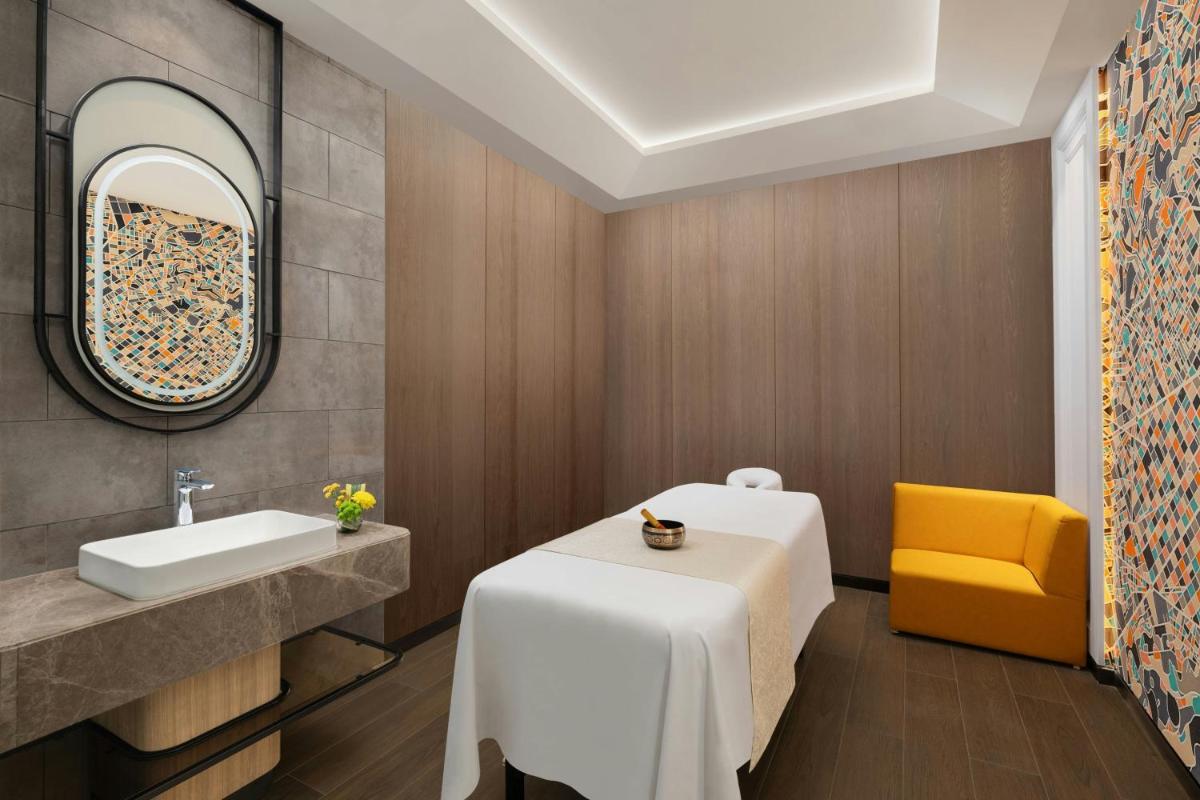 a bathroom with a white table and a yellow chair at Le Meridien Ahmedabad in Ahmedabad