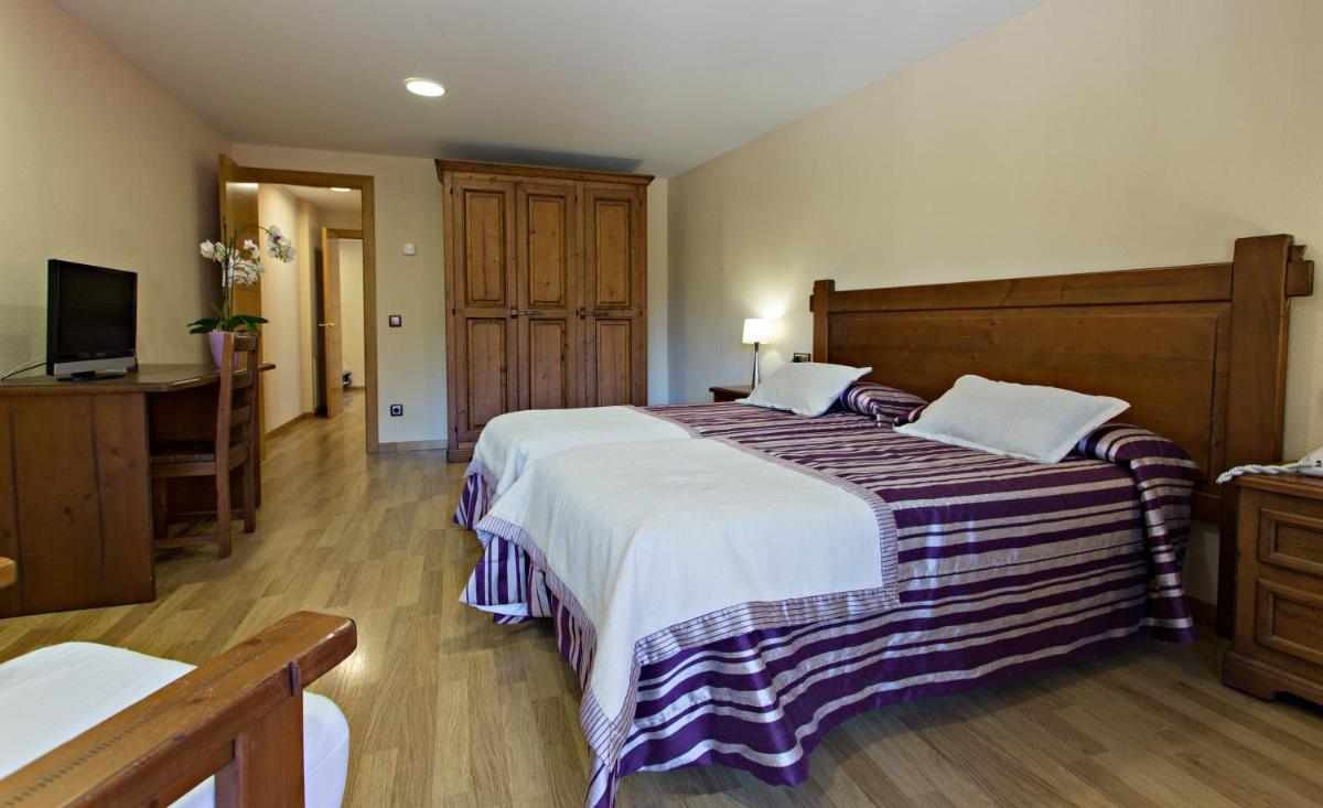 Cama o camas de una habitación en Hotel La Coma