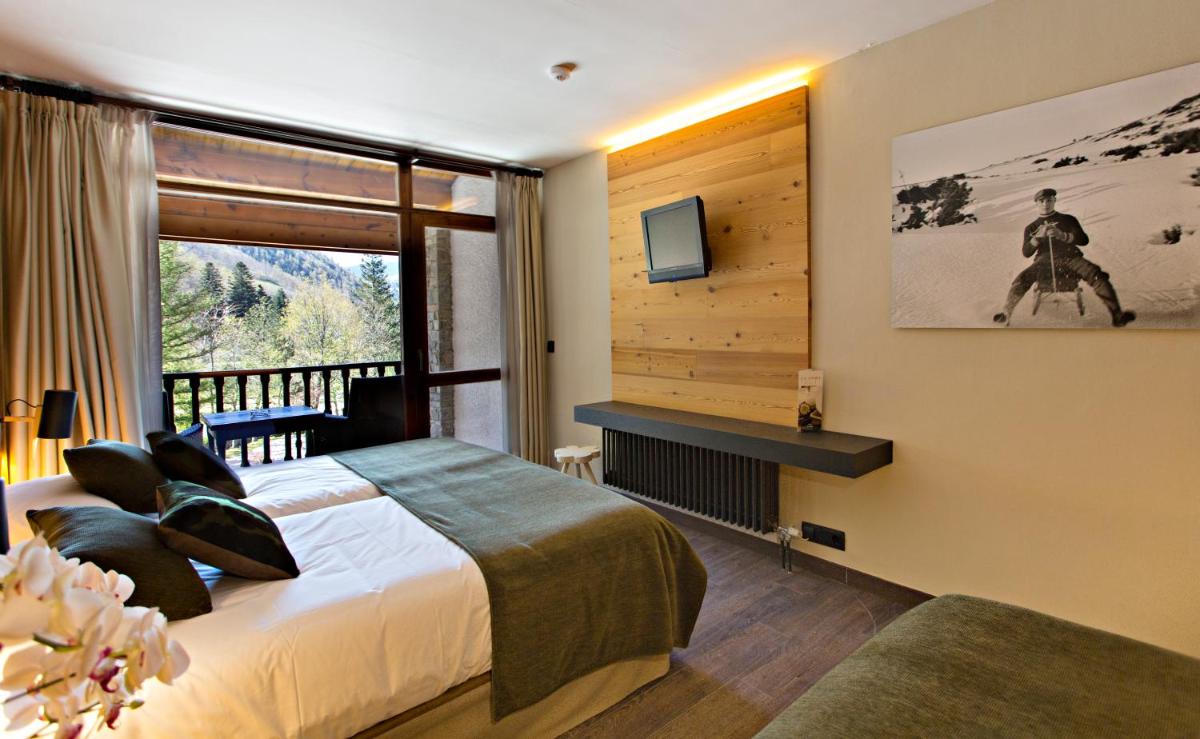 Un dormitorio con una cama grande y una ventana. en Hotel La Coma, en Setcases 37 fotos más