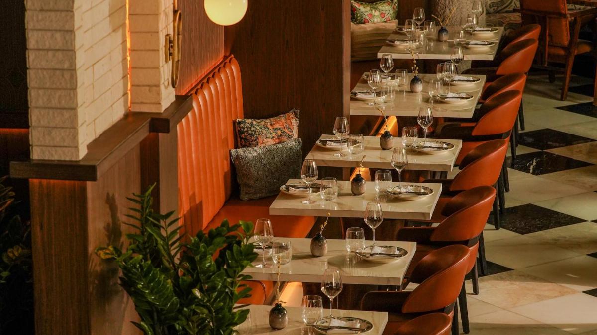 a row of tables in a restaurant with wine glasses at InterContinental Marine Drive Mumbai by IHG in Mumbai