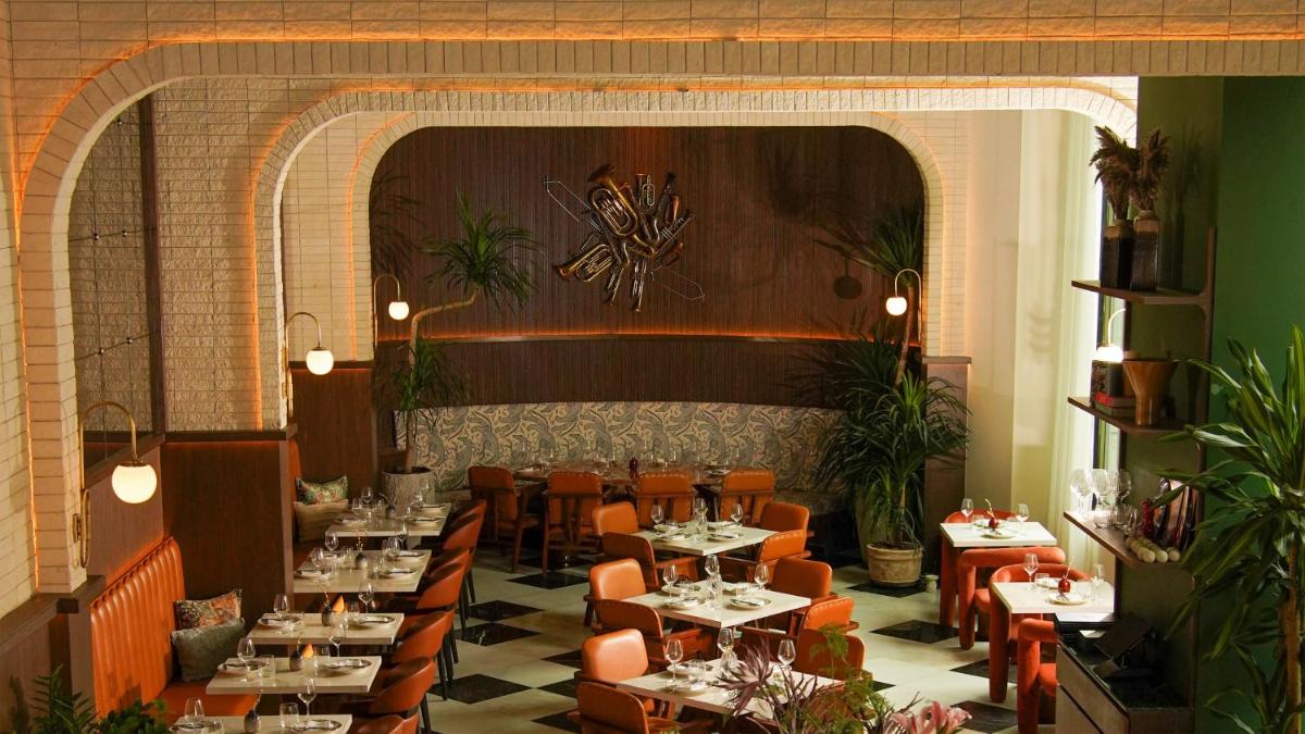 a restaurant with tables and chairs in a room at InterContinental Marine Drive Mumbai by IHG in Mumbai