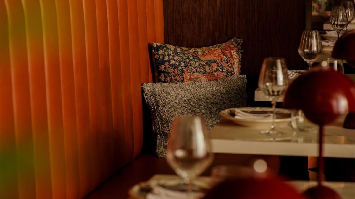a table with wine glasses and a pillow in a restaurant at InterContinental Marine Drive Mumbai by IHG in Mumbai