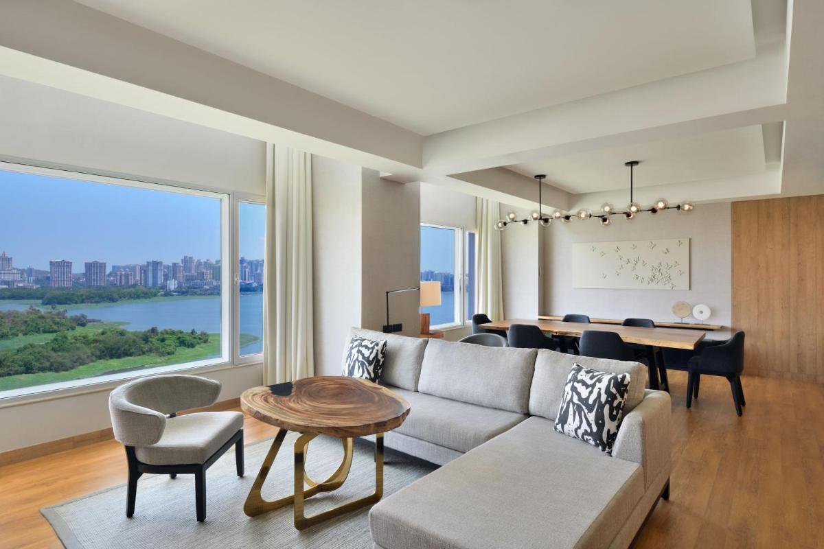 a living room with a couch and a table at The Westin Mumbai Powai Lake in Mumbai