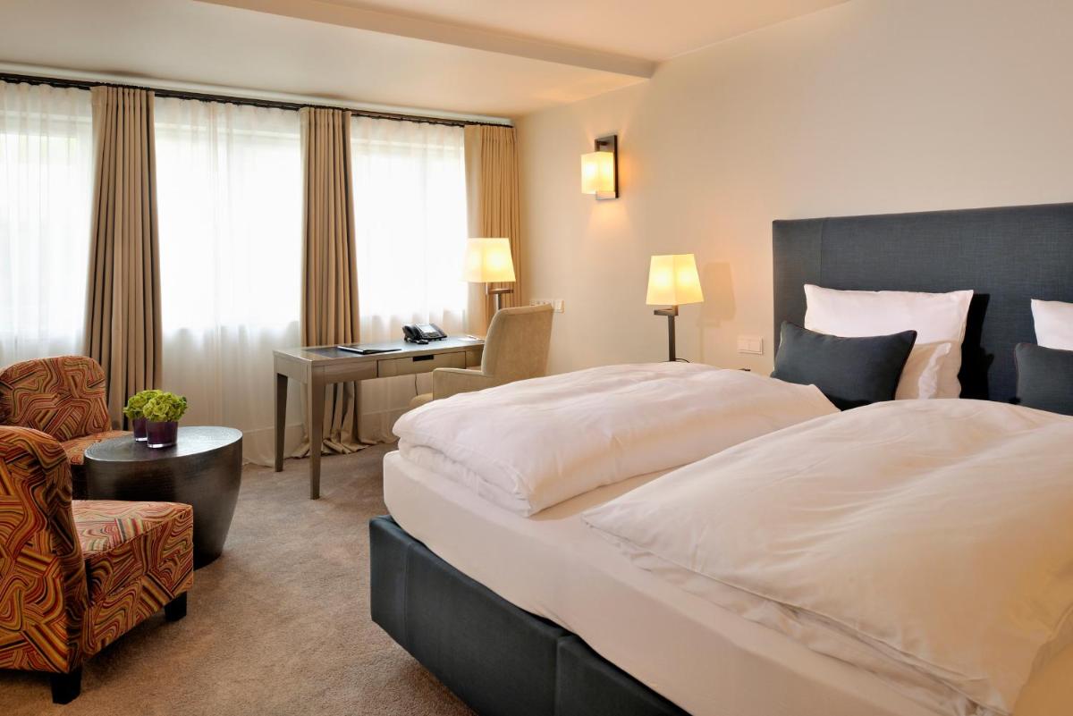 Ein Bett oder Betten in einem Zimmer der Unterkunft RIVA - Das Hotel am Bodensee
