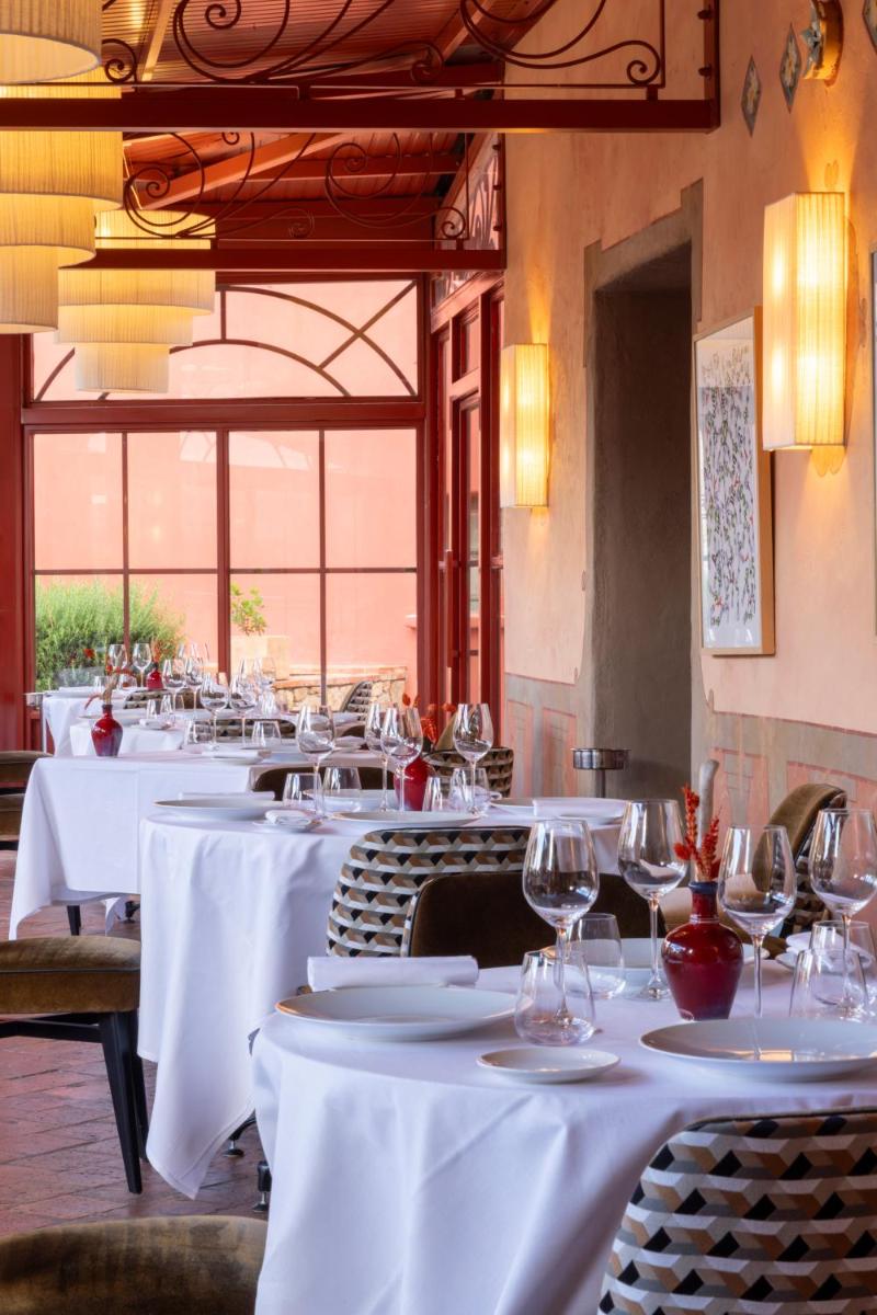 une rangée de tables dans un restaurant avec des verres à vin dans l'établissement La Signoria & Spa, à Calvi