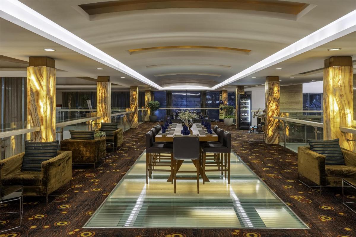 a dining room with a long table and chairs at Radisson Blu Hotel Pune Kharadi in Pune