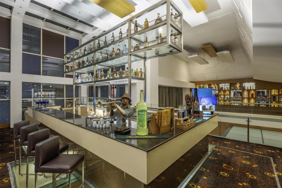 a bar at a hotel with a man playing a saxophone at Radisson Blu Hotel Pune Kharadi in Pune