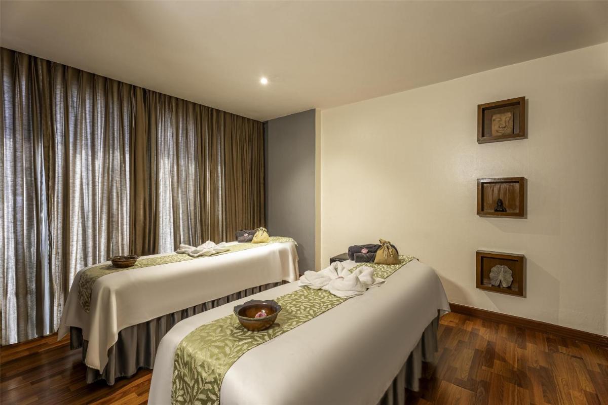 a hotel room with two beds and a window at Radisson Blu Hotel Pune Kharadi in Pune