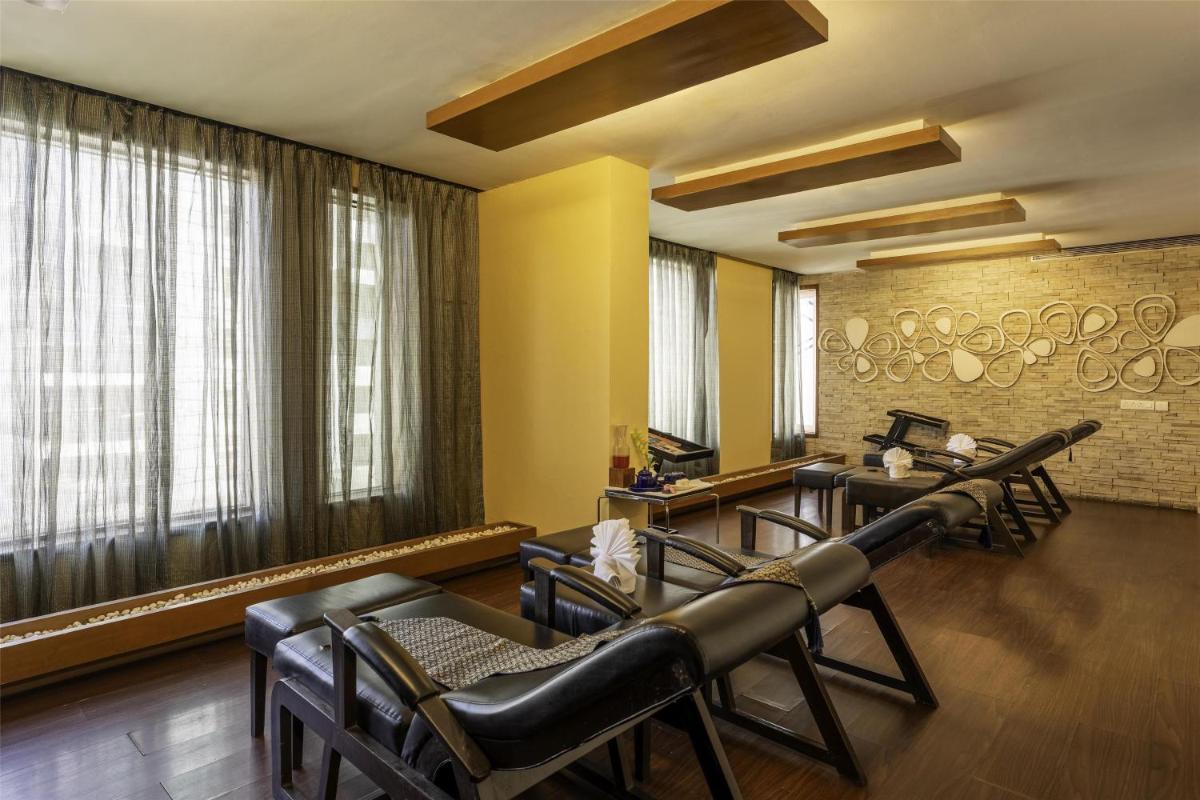 a hairdressing salon with leather chairs and a barber shop at Radisson Blu Hotel Pune Kharadi in Pune