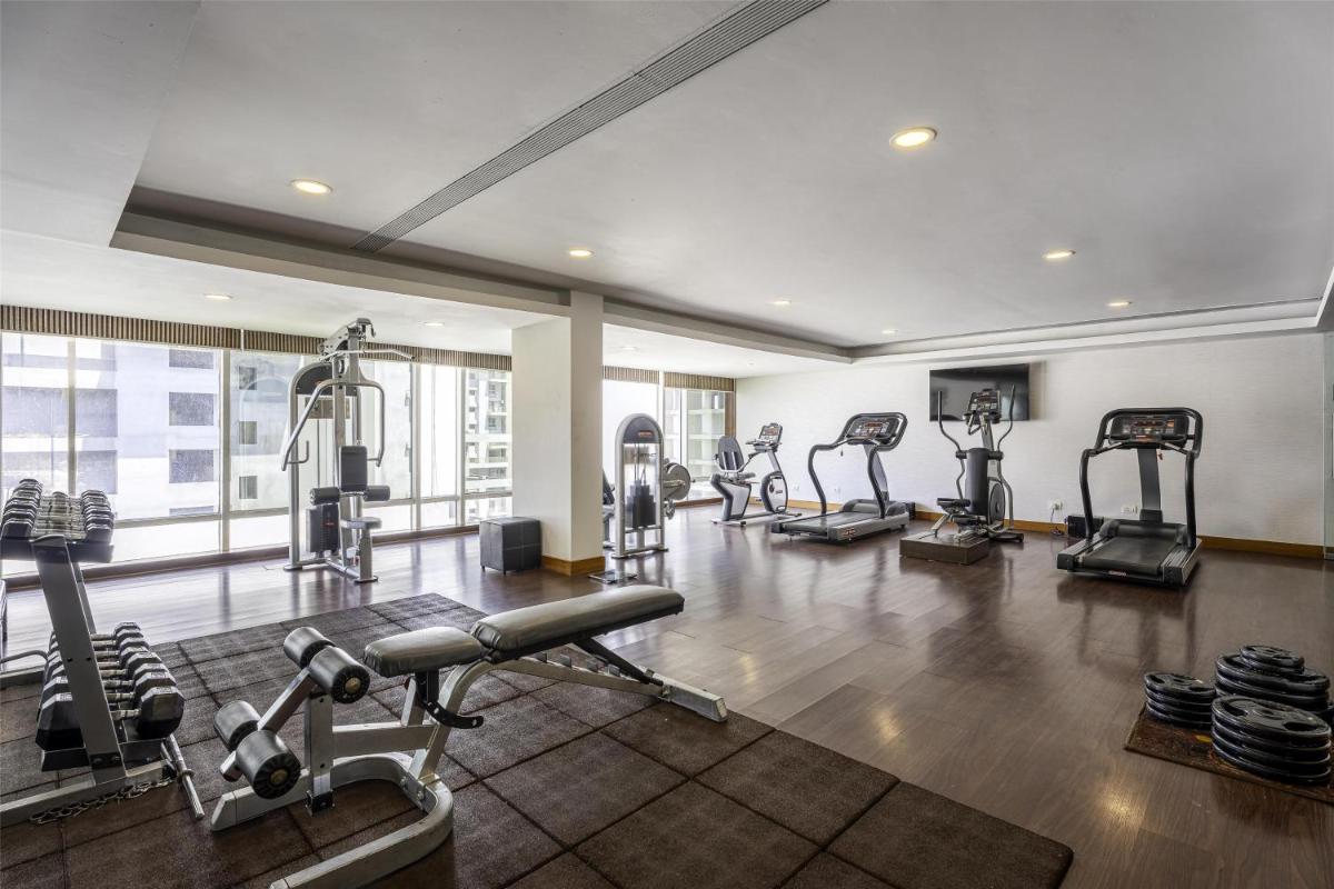 a gym with several tread machines in a room at Radisson Blu Hotel Pune Kharadi in Pune