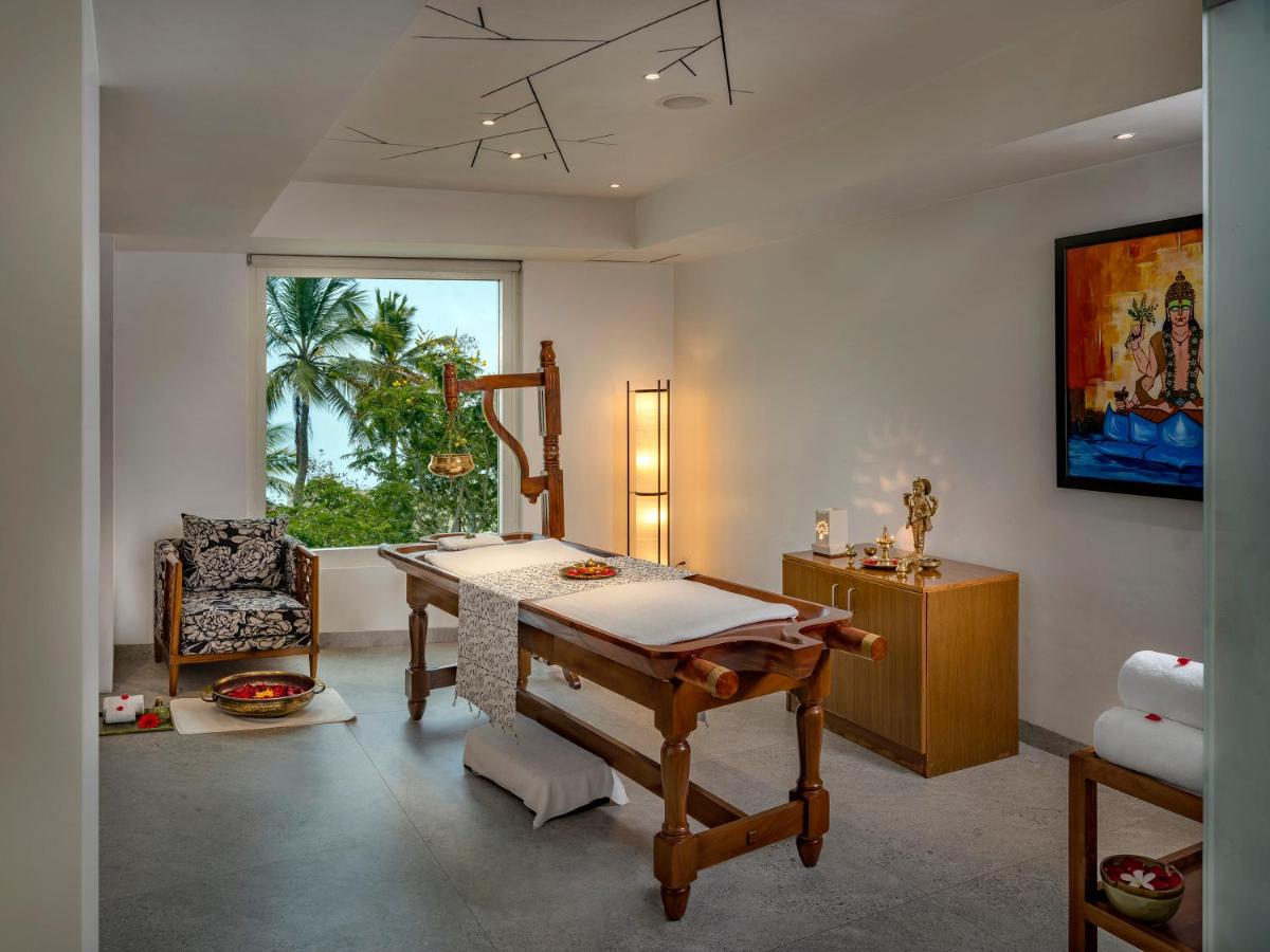 a room with a table and a chair and a window at O by Tamara, Trivandrum in Trivandrum