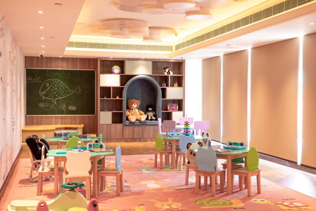 a classroom with tables and chairs and a chalkboard at DoubleTree by Hilton Agra in Agra