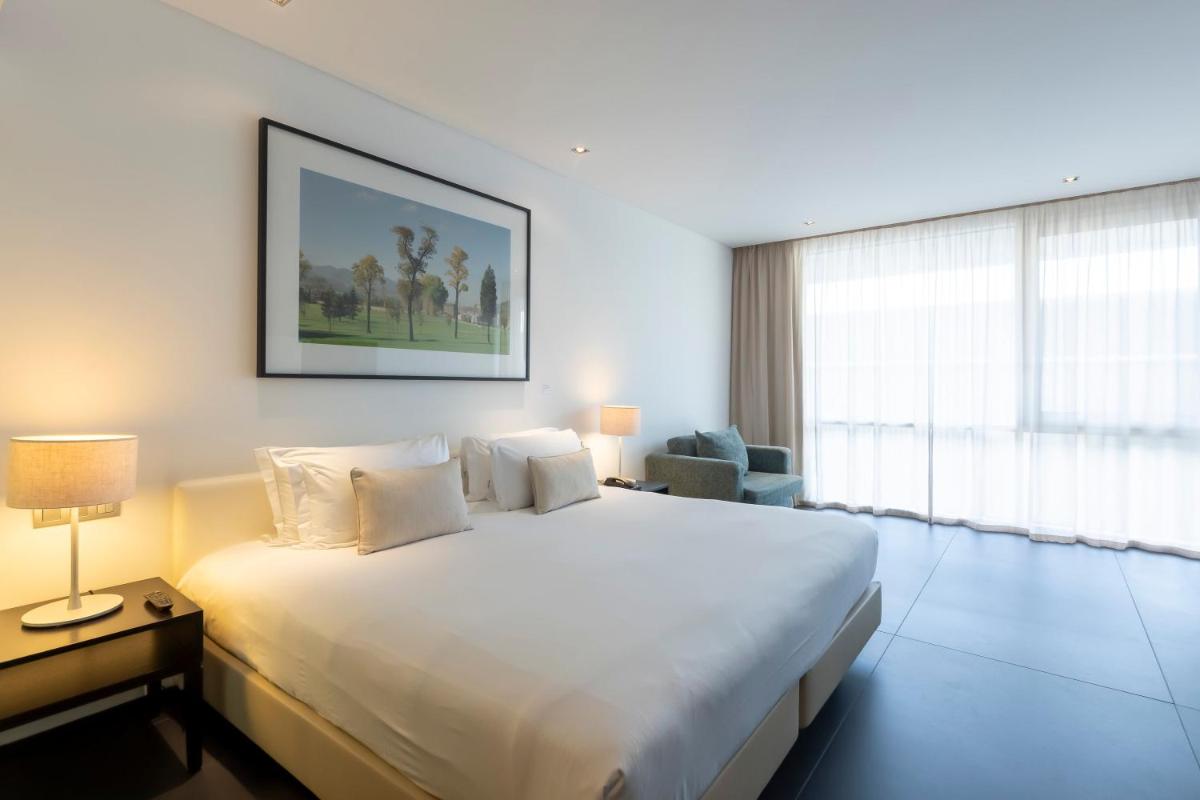 Uma cama ou camas num quarto em Troia Design Hotel