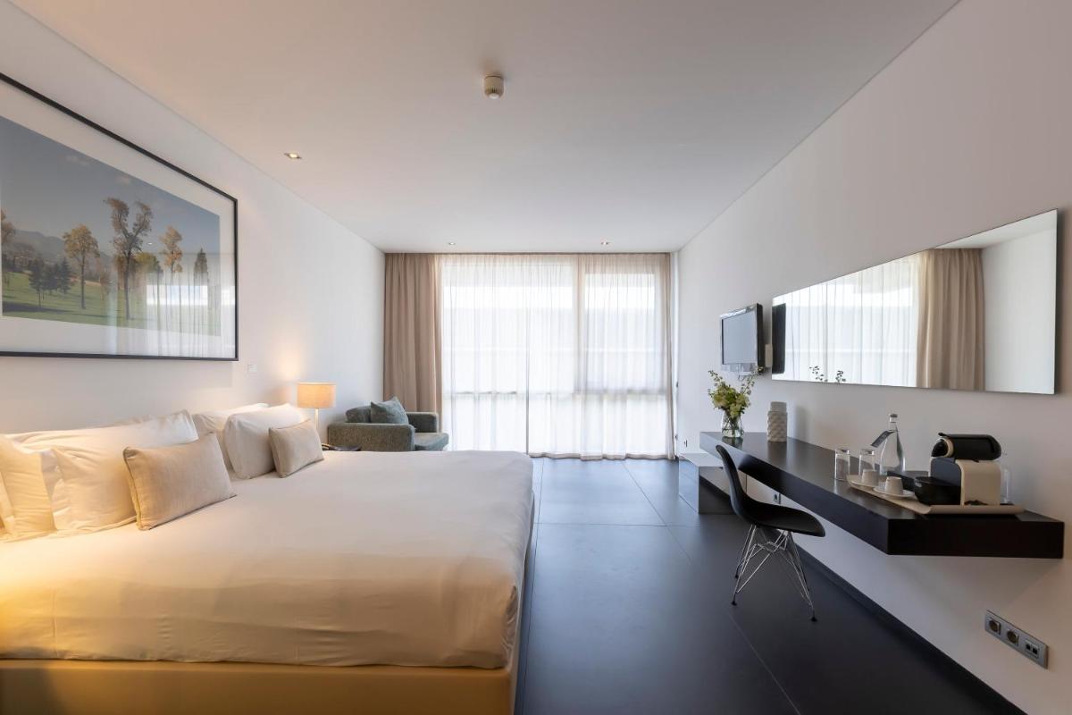 Uma cama ou camas num quarto em Troia Design Hotel