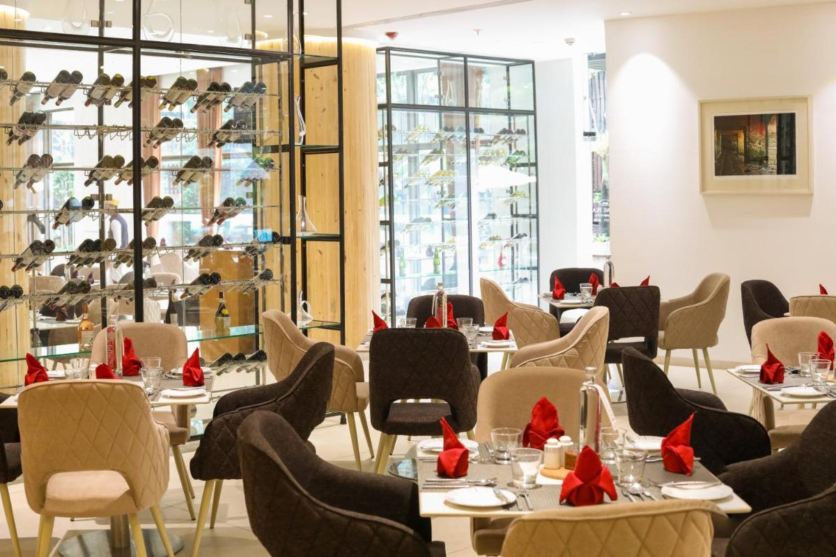 a restaurant with tables and chairs with red bows at Crowne Plaza Pune City Centre by IHG in Pune