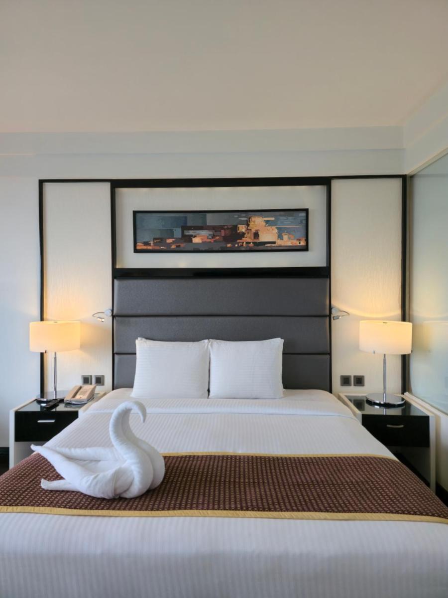 a bedroom with a large bed with a swan on it at Crowne Plaza Pune City Centre by IHG in Pune