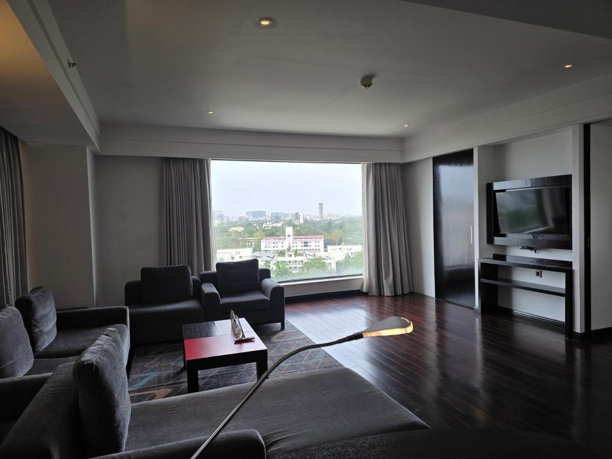 a living room with a couch and a television at Crowne Plaza Pune City Centre by IHG in Pune