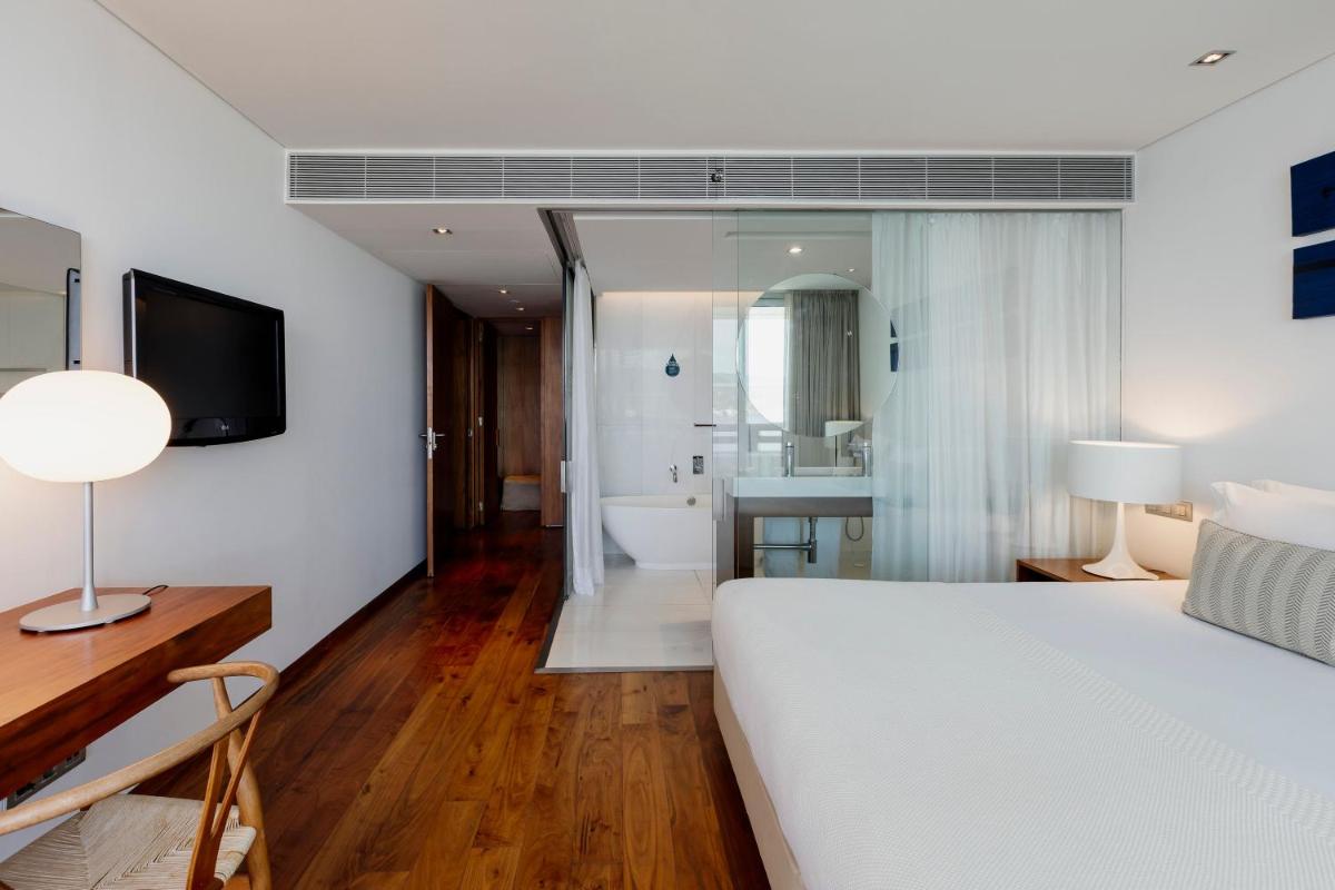 Uma cama ou camas num quarto em Troia Design Hotel
