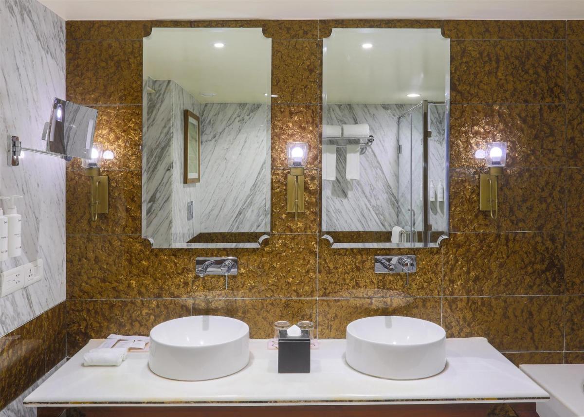a bathroom with two sinks and a large mirror at Radisson Jodhpur in Jodhpur