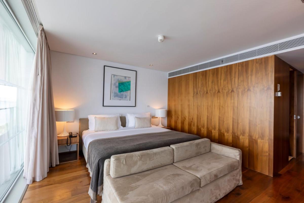 Uma cama ou camas num quarto em Troia Design Hotel