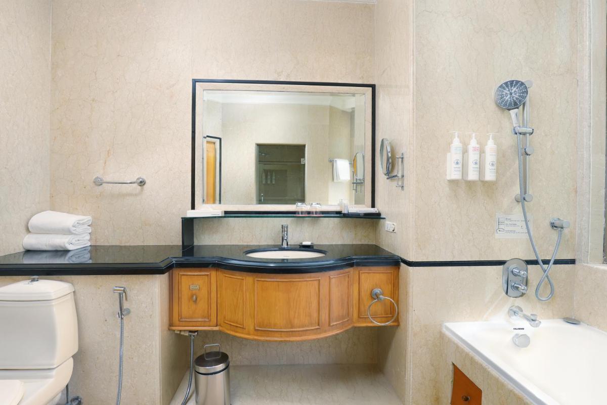 a bathroom with a sink and a mirror at Le Royal Meridien Chennai in Chennai