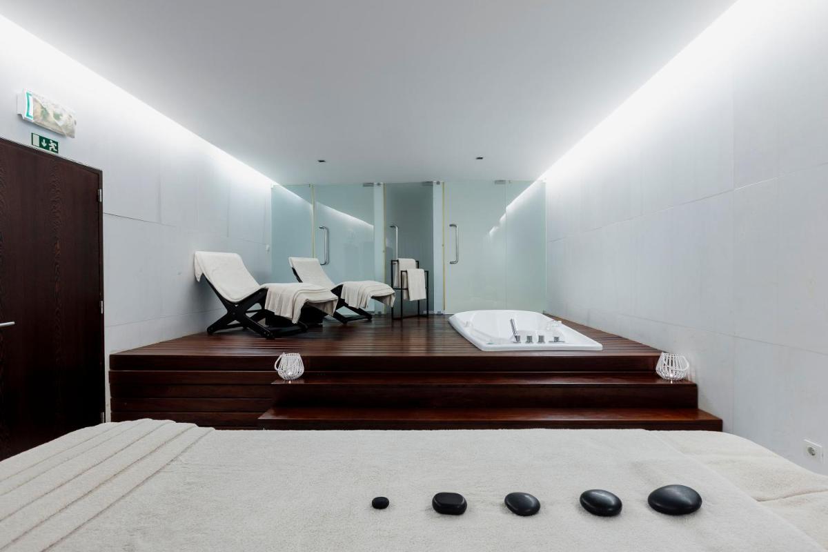 Uma cama ou camas num quarto em Troia Design Hotel