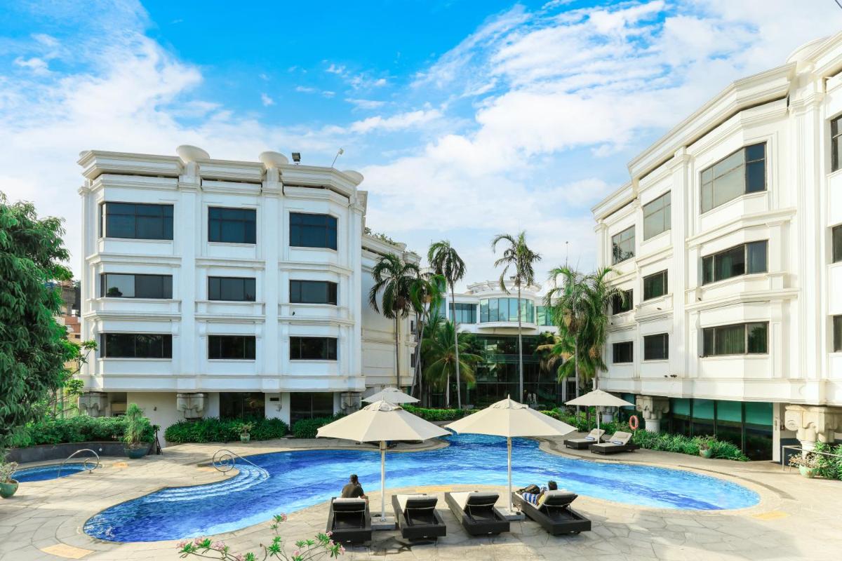 a hotel with a swimming pool and two buildings at Le Royal Meridien Chennai in Chennai
