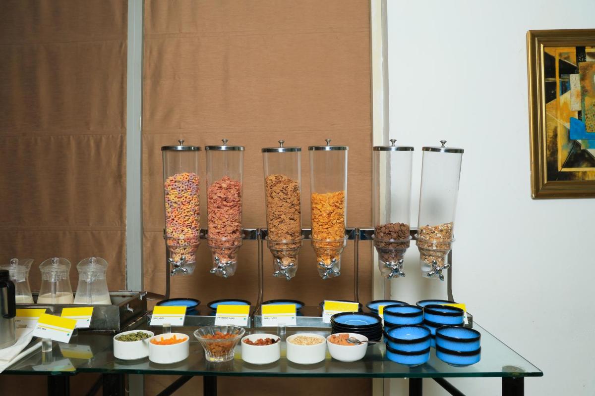 a table with a bunch of food in glass vases at Le Royal Meridien Chennai in Chennai