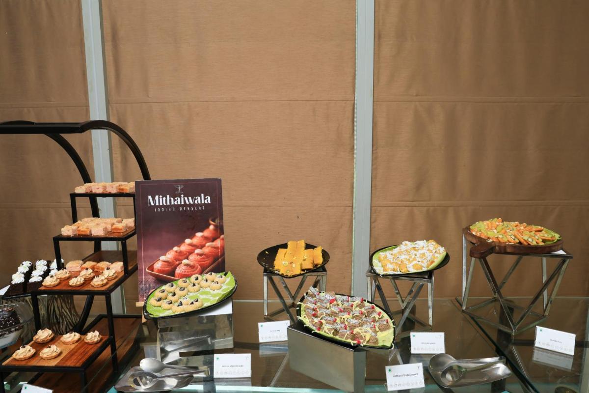a display of different types of pastries on a table at Le Royal Meridien Chennai in Chennai