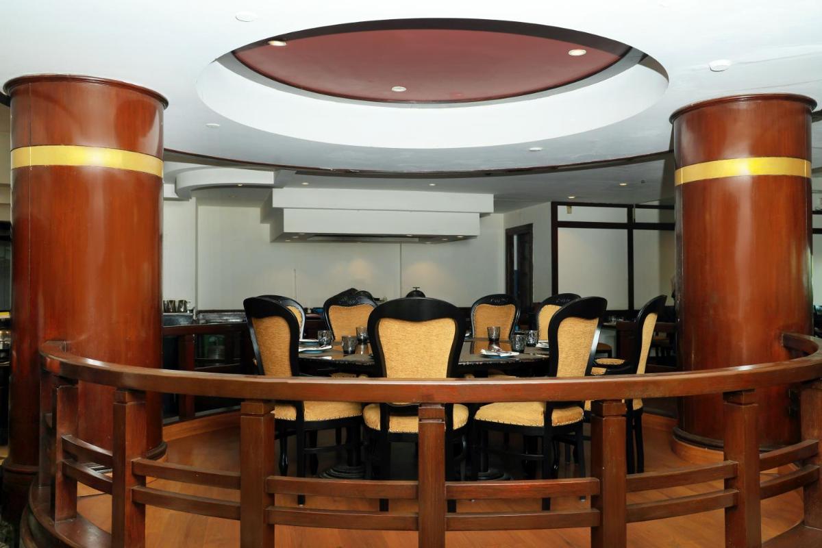 a conference room with a round table and chairs at Le Royal Meridien Chennai in Chennai