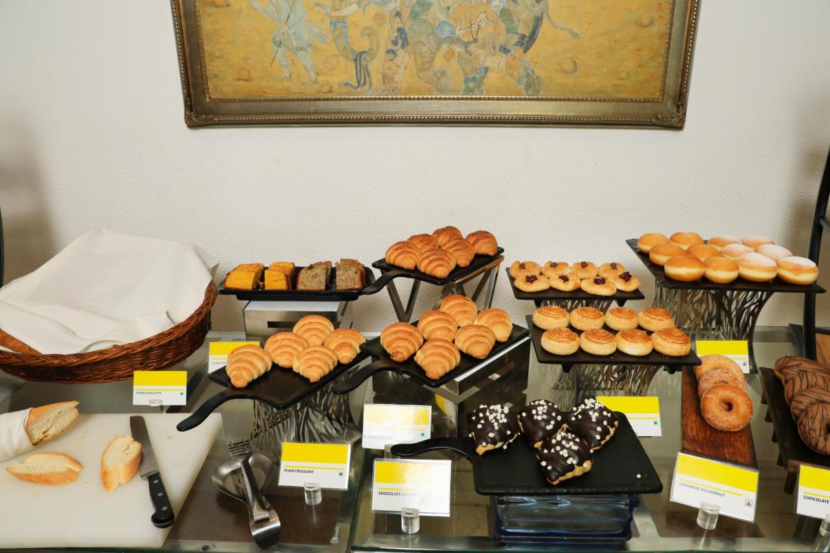 a table with many different types of bread and pastries at Le Royal Meridien Chennai in Chennai