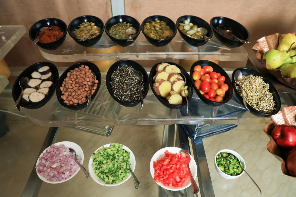 a display case with bowls of different types of food at Le Royal Meridien Chennai in Chennai