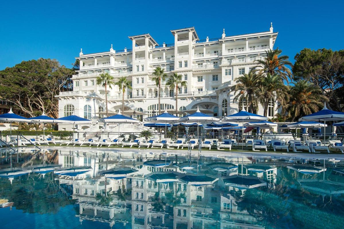 un hotel con piscina frente a un edificio en Gran Hotel Miramar GL, en Málaga