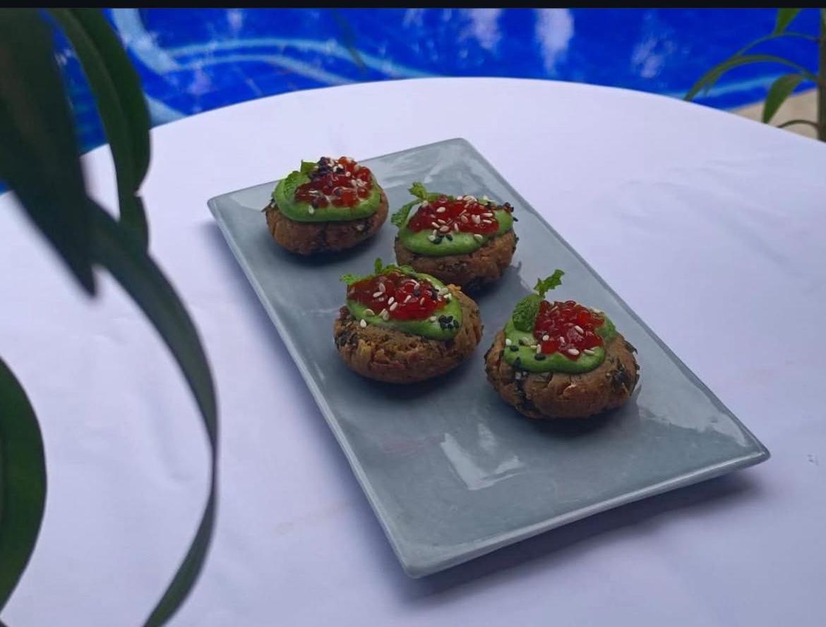 four muffins on a plate on a table at The Postcard Saligao in Calangute
