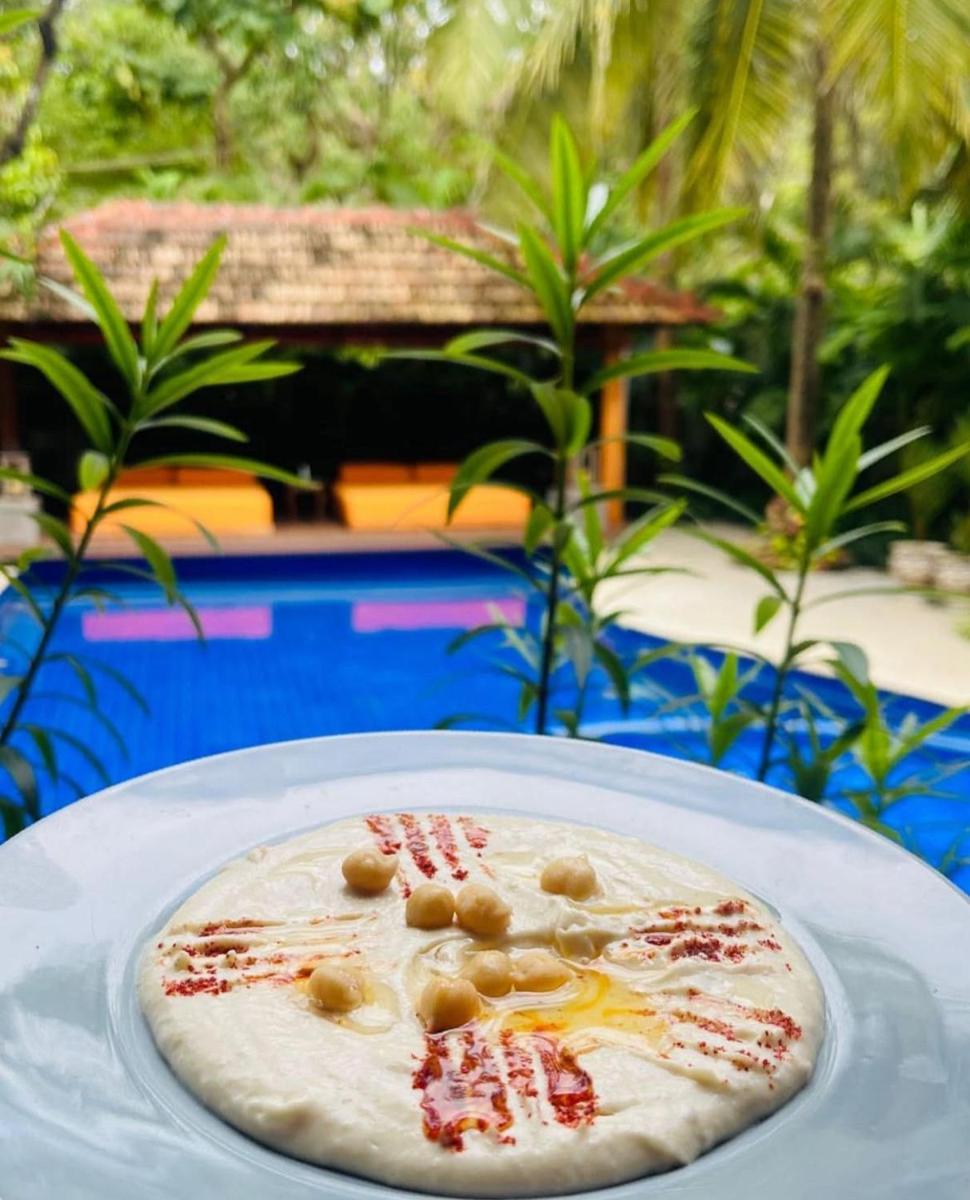 a plate of food on top of a table at The Postcard Saligao in Calangute