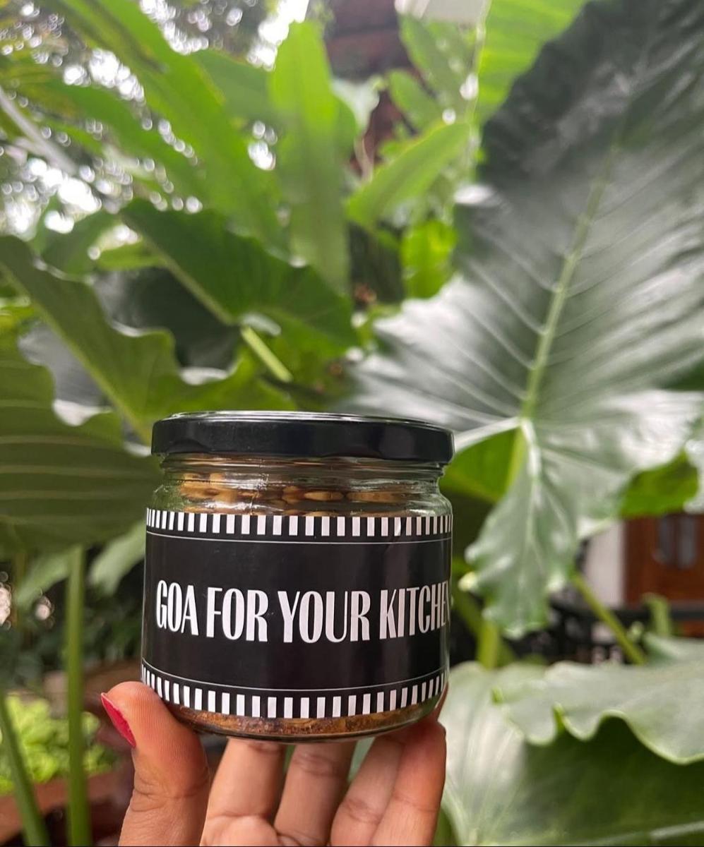 a person holding a jar of cea for your kitchen at The Postcard Saligao in Calangute