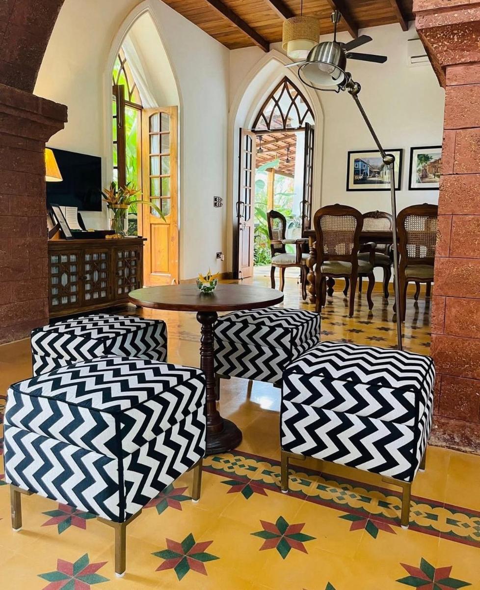 a living room with a table and chairs at The Postcard Saligao in Calangute