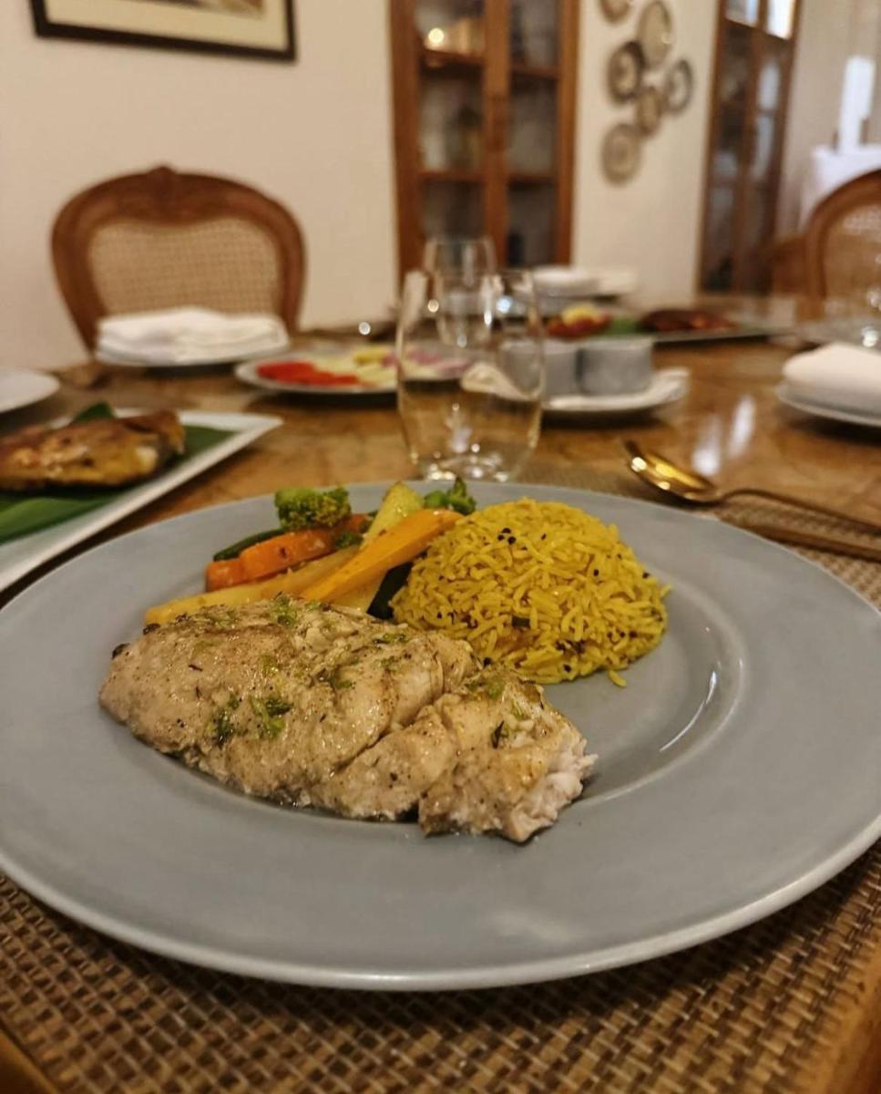 a plate of food on a table with food at The Postcard Saligao in Calangute