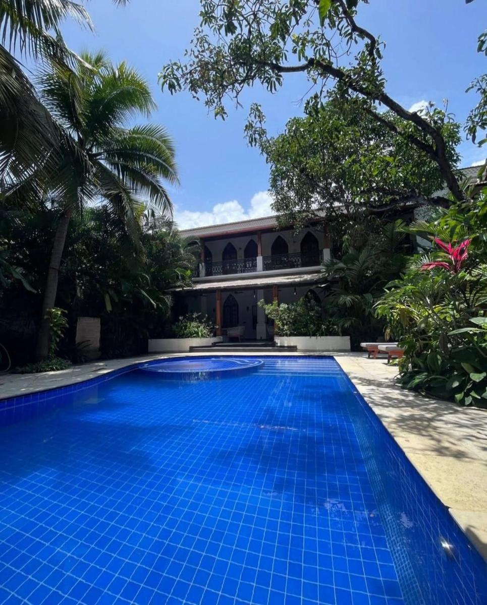 an empty swimming pool in front of a villa at The Postcard Saligao in Calangute