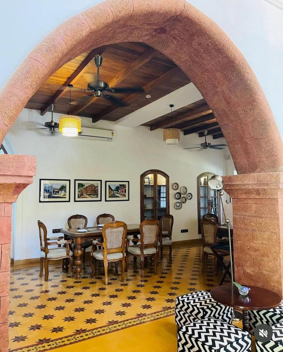 a dining room with a table and chairs at The Postcard Saligao in Calangute