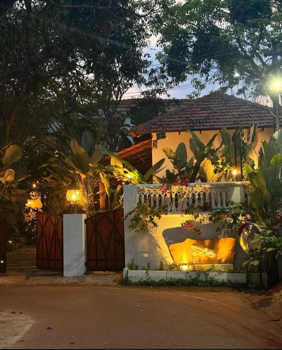 a house with a fireplace in a yard at night at The Postcard Saligao in Calangute