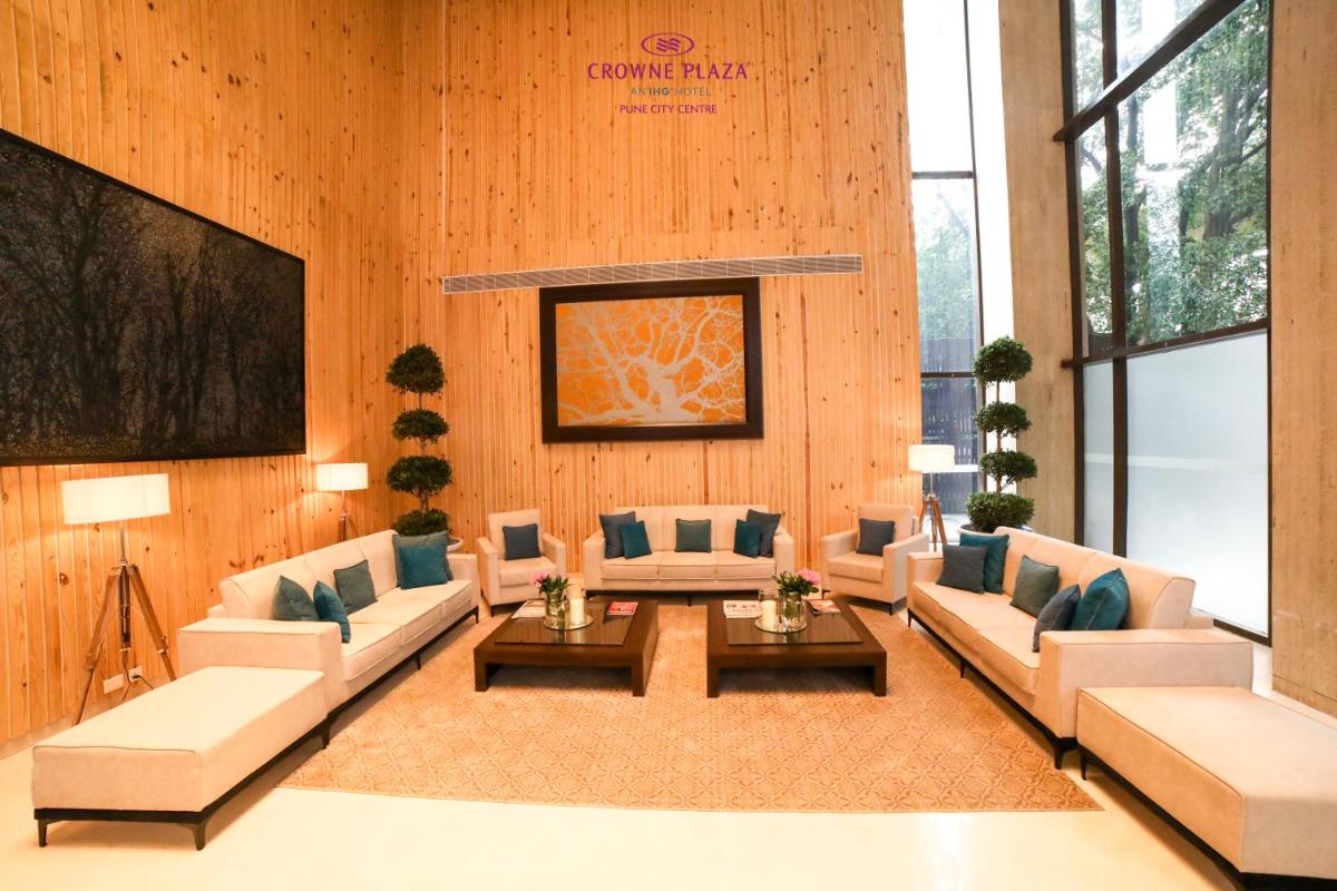 a large living room with couches and a table at Crowne Plaza Pune City Centre by IHG in Pune