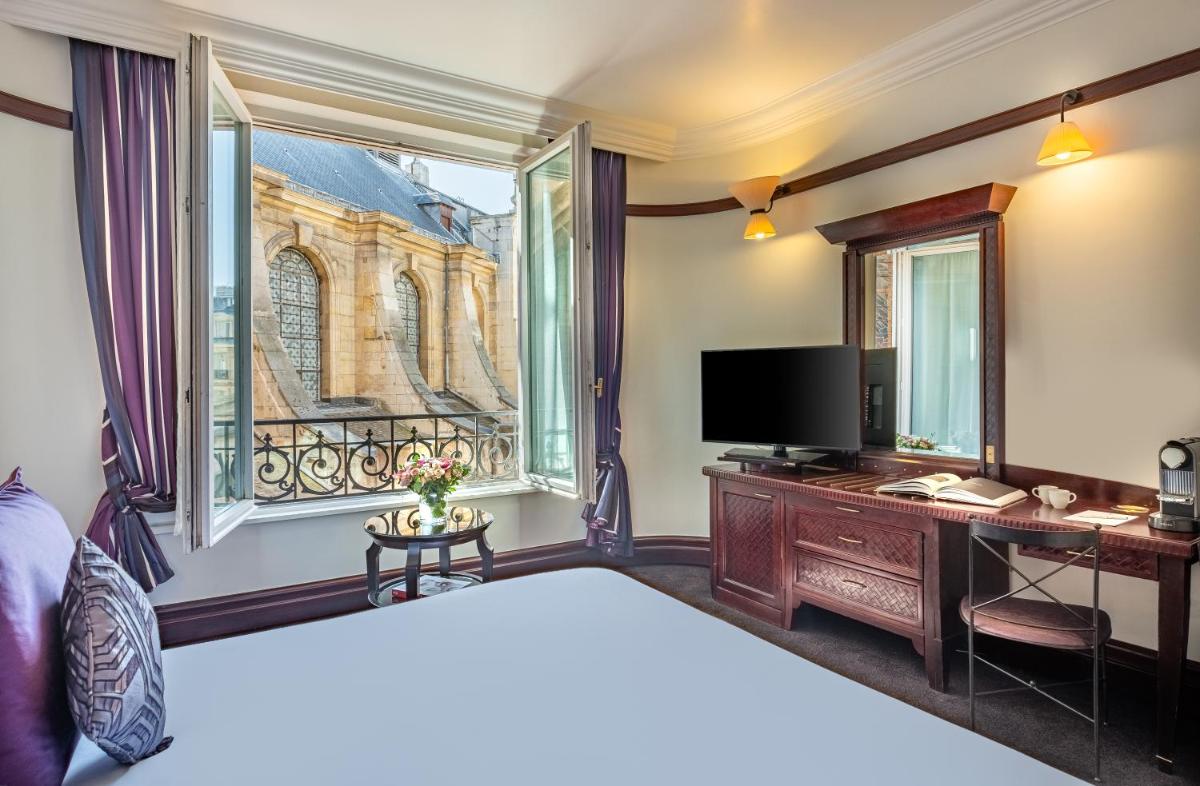 Un ou plusieurs lits dans un hébergement de l'établissement Hôtel Pont Royal Paris