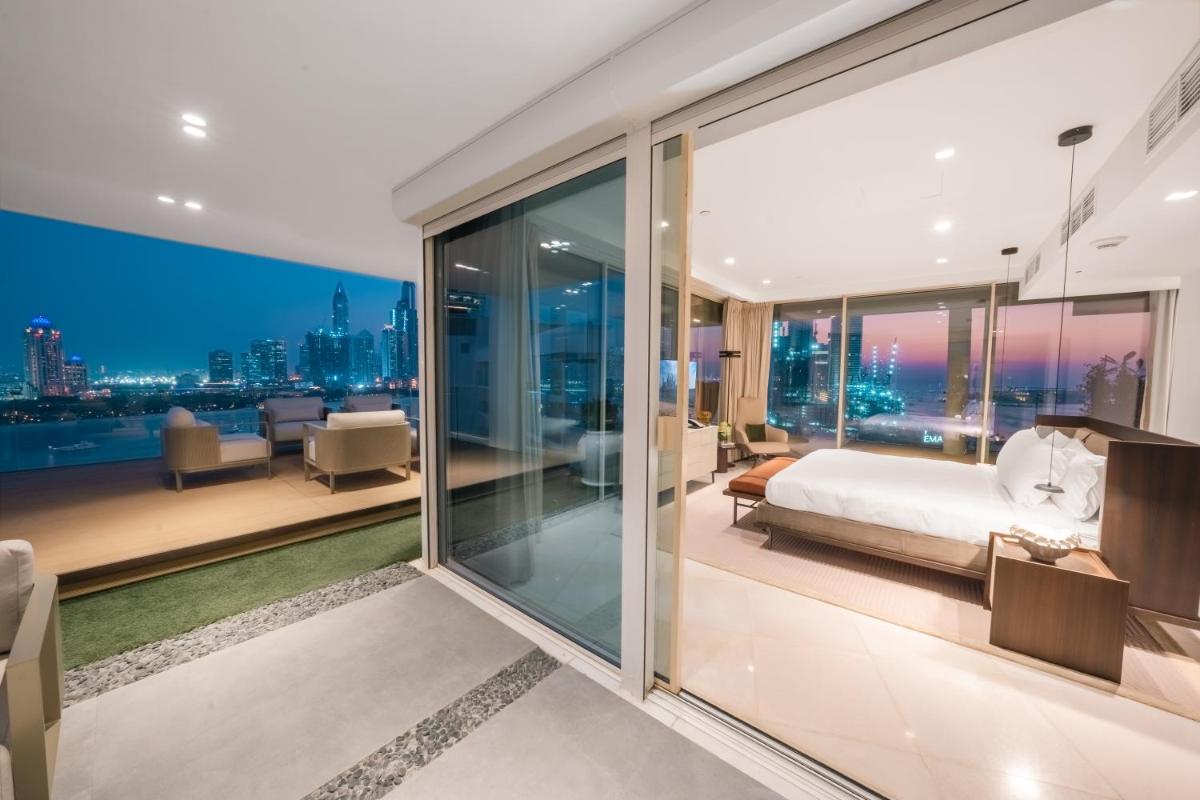 a bedroom with a bed and a view of the city at FIVE Palm Jumeirah Dubai in Dubai
