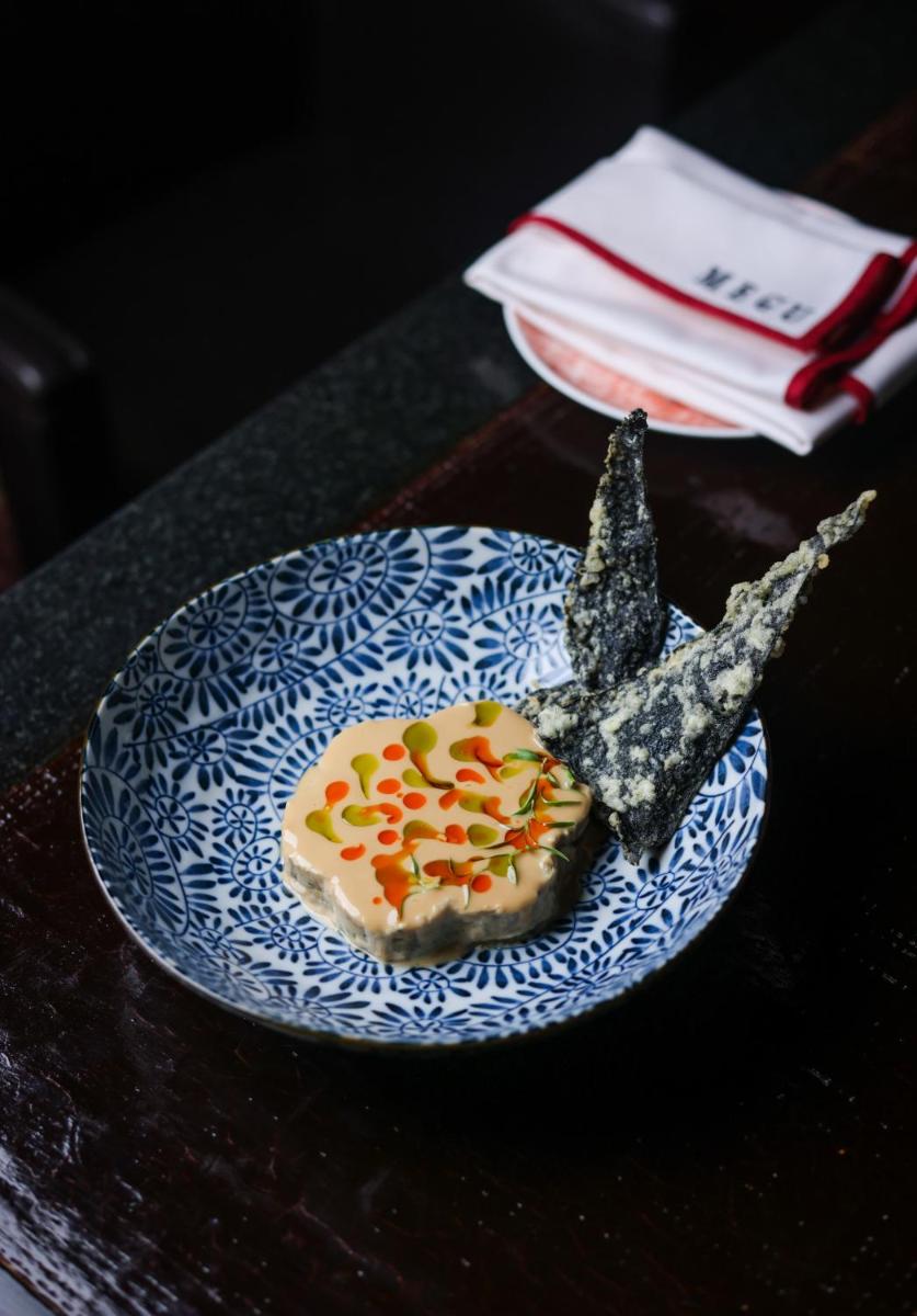 a piece of cake on a blue and white plate at The Leela Palace New Delhi in New Delhi a piece of cake on a blue and white plate at The Leela Palace New Delhi in New Delhi